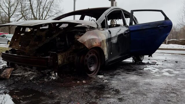 Abandoned burned out car after crime in city center