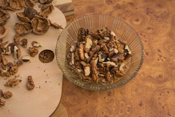 Peeled and shelled walnuts are scattered randomly on the table.