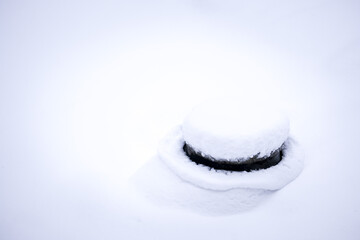concrete pipe under the snow, construction materials under the snow, selective focus