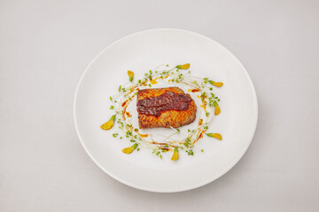 Pan Fried Salmon with Passion Fruit Sauce and sesban flower, isolated on white background, top view