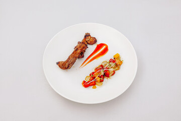 Grilled pork ribs with chili sauce, vegetable salad, isolated on white background, top view
