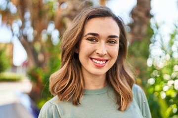 Young woman smiling confident standing at park