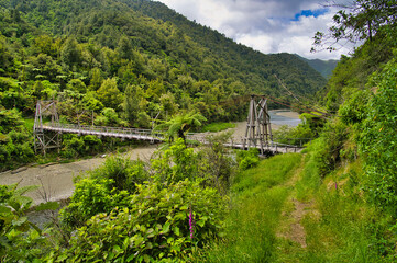 The historic Tauranga Bridge, a suspension bridge spanning the Waioeka River in Waioeka Gorge Scenic Reserve, between Tauranga and Opotiki, East Coast, North Island, New Zealand