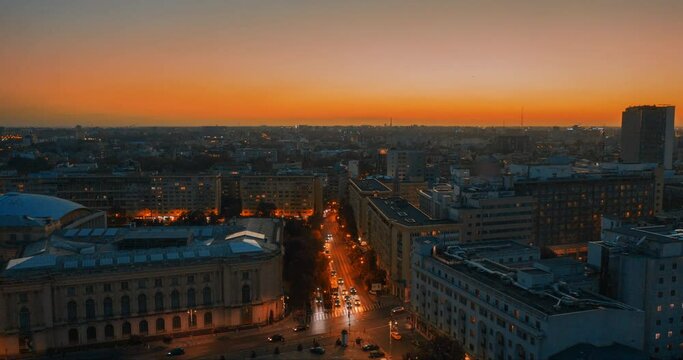 the sun sets over autumn bucharest. evening in a European city. urban active traffic in the old city - Aerial view Hyperlapse