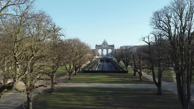 Cinquantenaire park (Jubelpark) and tunnel cinquantenaire road in Brussels. Drone aerial view from above towards Triumphal arch (Arc de Triomphe)