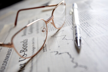 eyeglasses on the newspaper pages