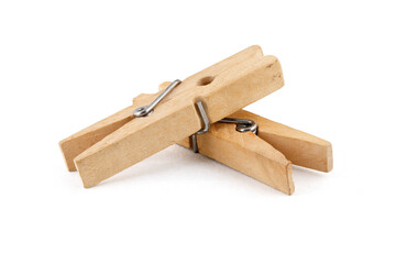 Two wooden clothespins, isolated on a white background, lying on their side. Close-up photo. Full depth of field.