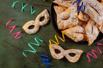 Carnival mask shape pastry Angel wings or sfrappole or chiacchiere. Directly above. Crisp dessert...