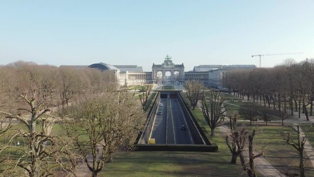 Cinquantenaire park (Jubelpark) and tunnel cinquantenaire road in Brussels. Drone aerial view from above towards Triumphal arch (Arc de Triomphe)