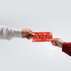 Chinese Lunar New Year. People giving red envelope with blessing words contained money as a gift.