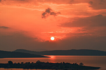 sunset reverse light sun after sunset blue hours tree people lighthouse birds watching sunset taking photo landscape