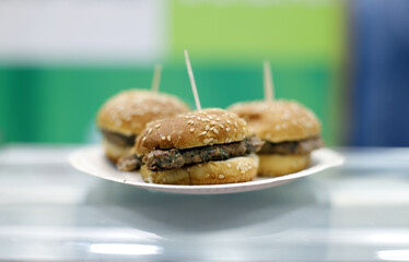 hamburguesas de carne en mostrador pinchadas con palitos
