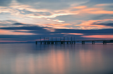 Fototapeta na wymiar blue hours after sunset boats reflection pier clouds castle