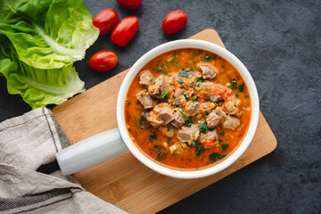 Chicken stomachs stewed in tomato sauce with vegetables
