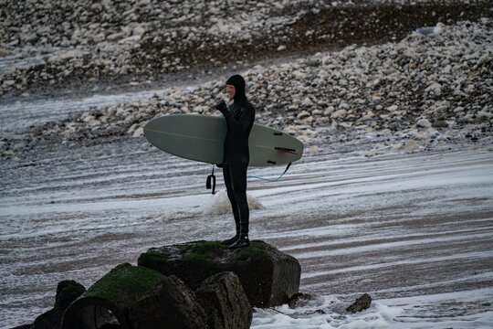 Surfer wait to catching waves in cold water in winter, cold hawaii, norre vorupor, Klitmoller and Hanstholm, denmark