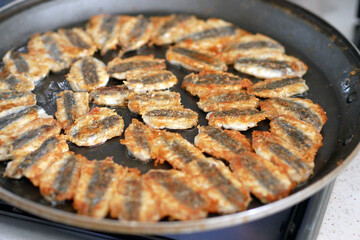 Anchovy is fried in a pan, cooking Turkish style anchovy, fried fish,