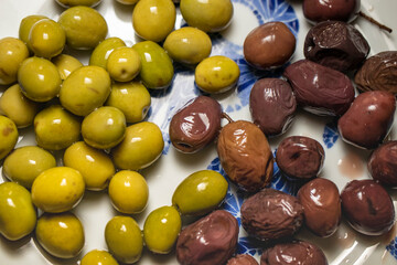 Organic olives in green and black on the breakfast plate.