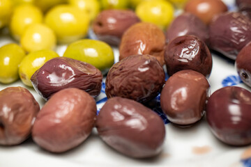 Organic olives in green and black on the breakfast plate.