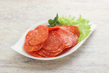 Sliced pepperoni sausage in the bowl