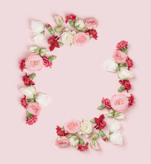 Colorful flowers arranged in a frame on a light pink background. Romantic, Valentine's template.