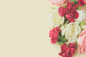 Spring flowers arranged against the pastel yellow background. Valentine's day, wedding backdrop.