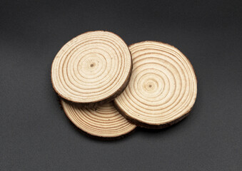 Fototapeta na wymiar Three pieces of cut wood of round shape with pronounced rings.