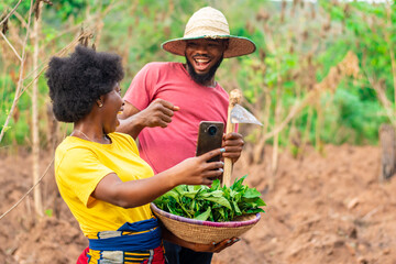 two african farmers excited after checking a phone