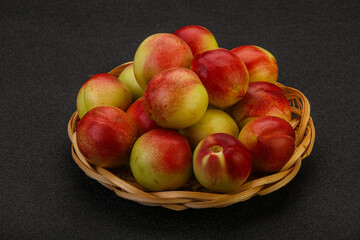 Sweet small nectarines in the basket