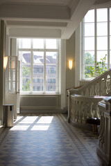 Bright classic stairway with wall lights