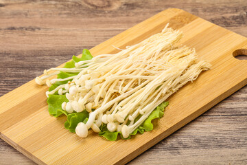 Raw Enoki mushrooms for cooking