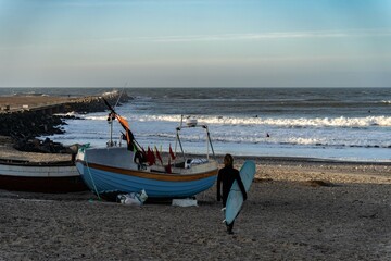 Naklejka premium Surfer wait to catching waves in cold water in winter, cold hawaii, norre vorupor, Klitmoller and Hanstholm, denmark