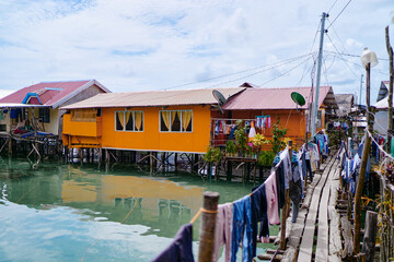 Fototapeta na wymiar Wooden houses on stilts, tropical village on the sea shore.