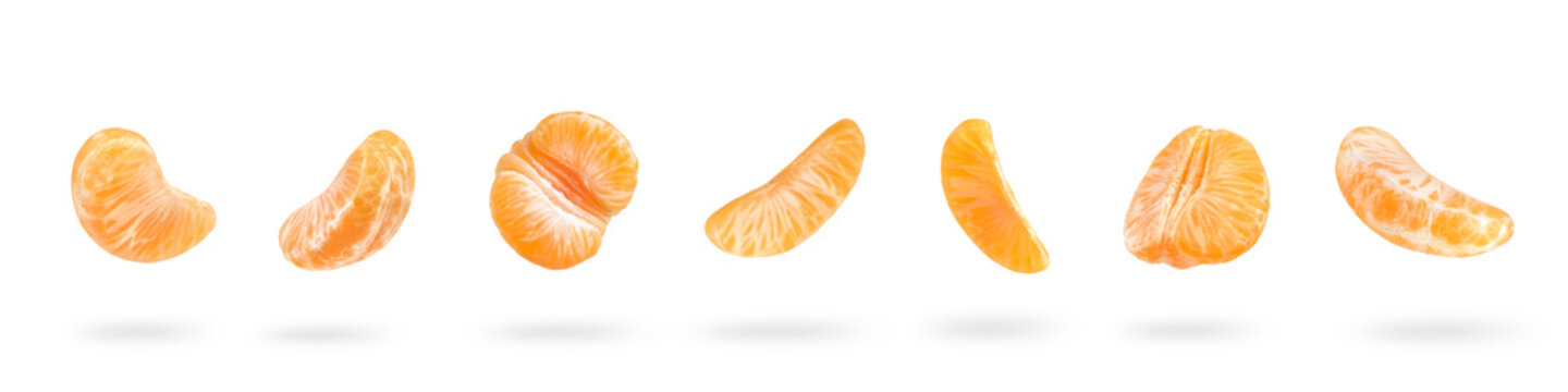 A large set of mandarin slices isolated on a white background falling down casting a shadow. Separate tangerine slices to insert into a project or design