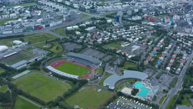 Birds eye view of sport complex in Reykjavik suburbs, Iceland, with swimming pool and football fields. Aerial view of Laugardalsvollur football arena, the home of the Icelandic national team