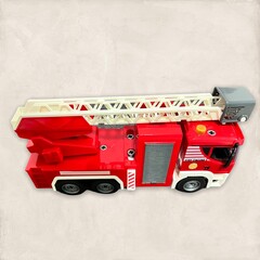 truck on the road. Red fire truck, children's toy is a red fire truck isolated on pink background