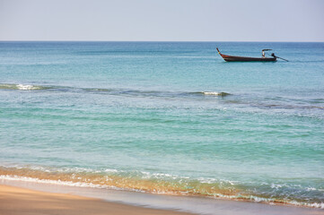 Fototapeta na wymiar Travel by Thailand. Sea beach with traditional longtail boat.