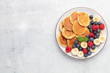 Keto pancakes made of diet flour or almond flour, served with berries.