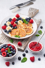 Keto pancakes made of diet flour or almond flour, served with berries.