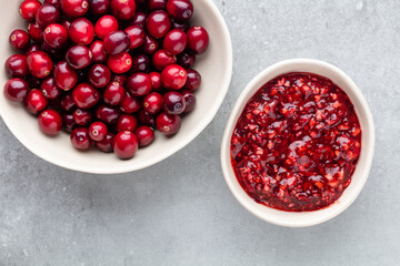 Red berries on a dark background. cranberries in a bowl.