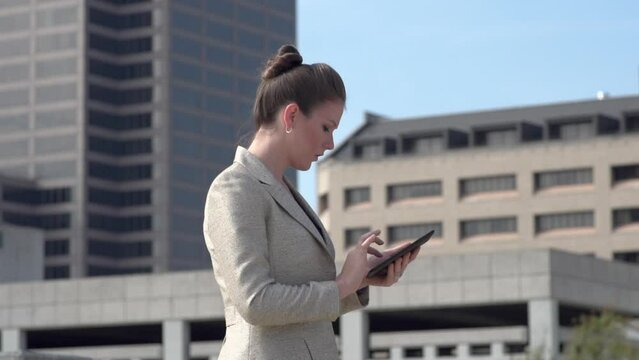 Businesswoman typing on tablet