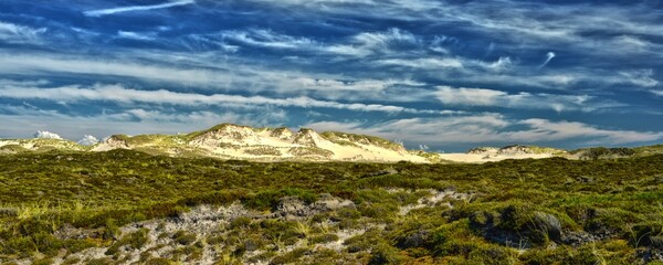 Idyllic huge wander dunes with sunlight beautiful clouds and blue sky Sylt Germany