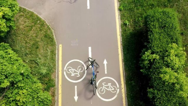 Bicycle on the roud on the background of Bicycle road sign and bike riders.