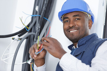 happy electrician technician at work