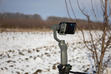 Steadicam for phone on a tripod. Blurred background.
