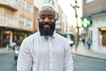 Obraz premium Young african american man smiling confident standing at street