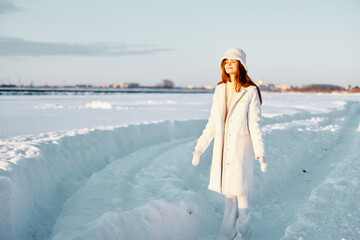 Fototapeta na wymiar young woman smile Winter mood walk white coat Fresh air