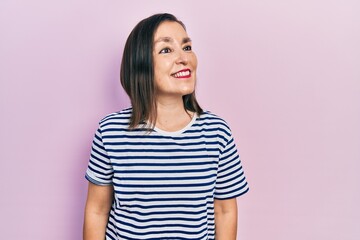 Fototapeta premium Middle age hispanic woman wearing casual clothes looking to side, relax profile pose with natural face and confident smile.