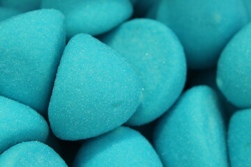 chewy blue-colored marmalade gumme shaped candy sphere truffles close-up. Background food. A day of sweet tooth