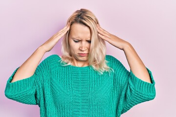 Beautiful caucasian blonde woman wearing casual winter sweater with hand on head, headache because stress. suffering migraine.