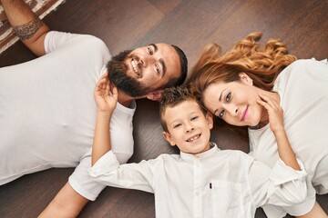 Family smiling confident lying on floor at home